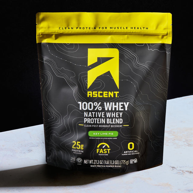 Image of Key Lime Pie protein powder on a kitchen counter with a black background