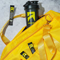 Yellow bag with Ascent and Rocket Creatine products on a concrete surface split_row_banner_1