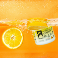 jar of clean hydration + energy powder half submerged stylistically underwater with orange slices