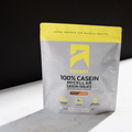 package of Ascent 100% Casein Micellar Casein Isolate Chocolate Peanut Butter flavor on a black background