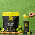 Ascent Key Lime Pie protein powder packaging with lime slices on a green background