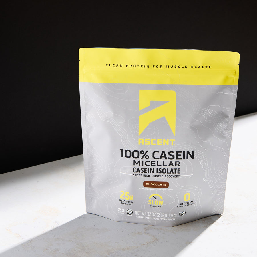 Protein powder package with yellow and gray design on a white surface