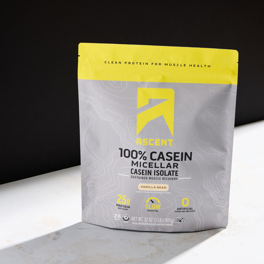 Ascent protein powder package on a white surface with a black background