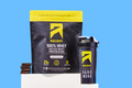 product shot of cookies & creme protein powder on a blue background with cookies and cup next to it
