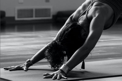 ascent protein athlete doing stretches on a yoga ma