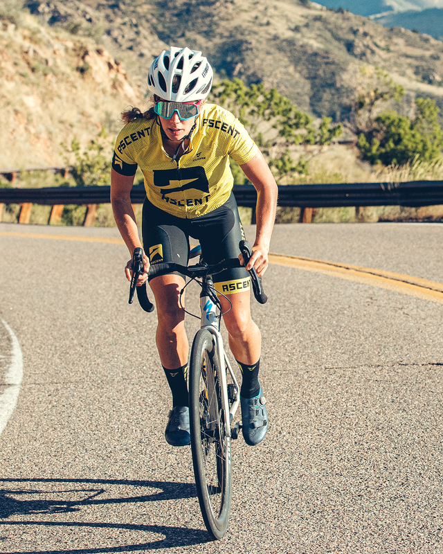 female on bicycle on a mountain road