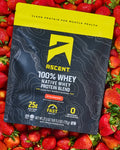 black & yellow bag of Ascent protein powder on a bed of strawberries
