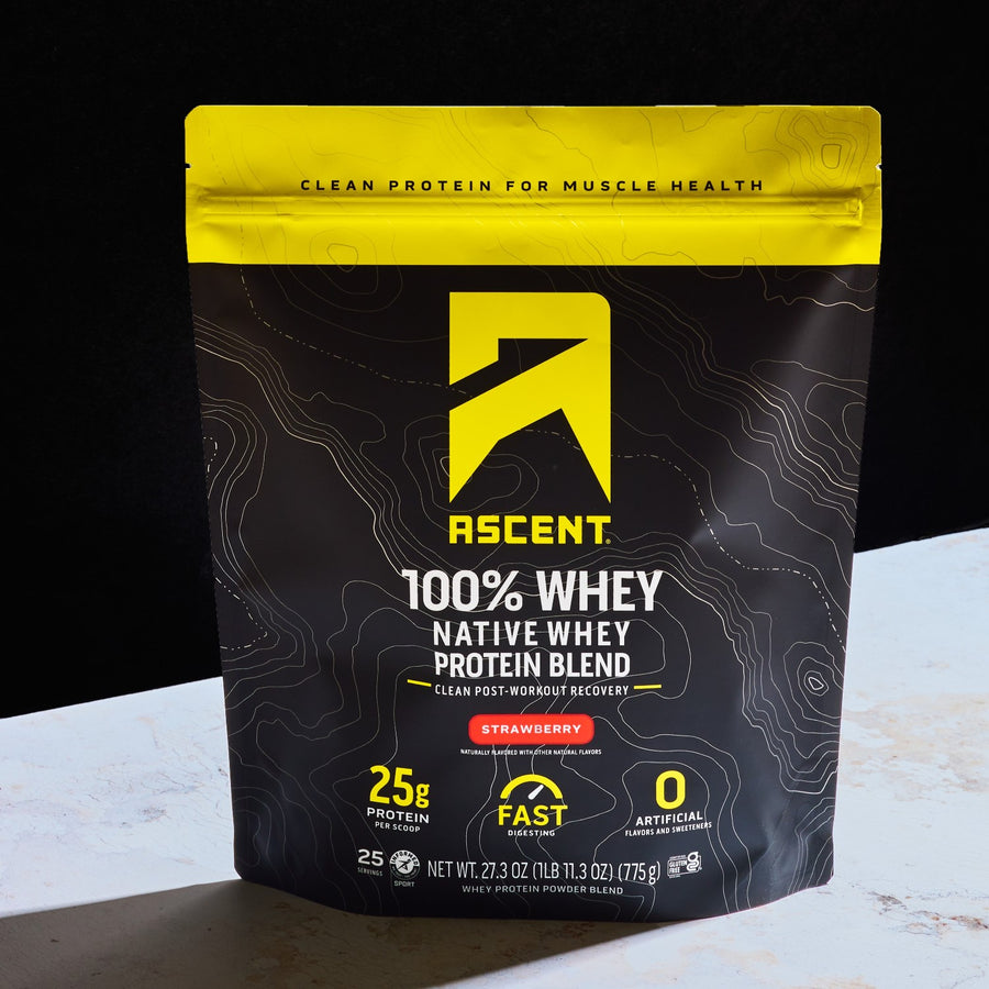 A package of Ascent 100% Whey Native Whey Protein Blend in strawberry flavor, with a black and yellow design, indicating 25g of protein per serving.