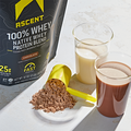 product image of a 2lb bag of chocolate peanut butter protein powder with a scoop of protein powder and protein shakes aside the 2lb bag