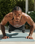 athlete doing a pushup looking into the camera