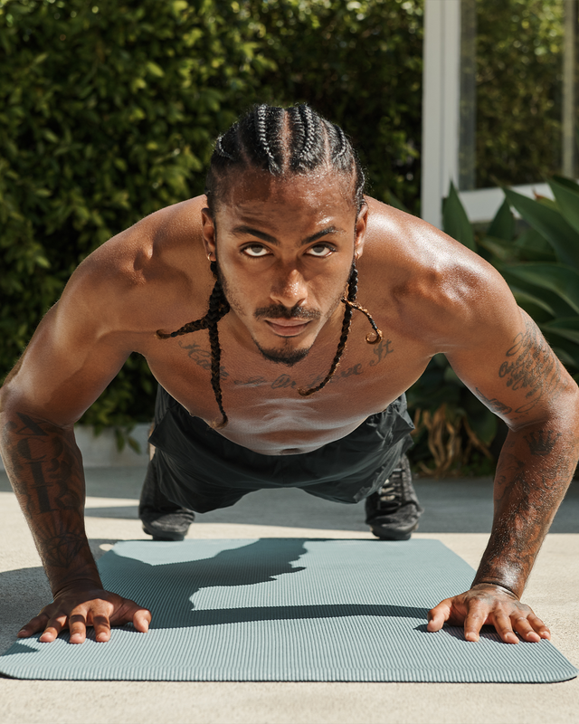 athlete doing a pushup looking into the camera